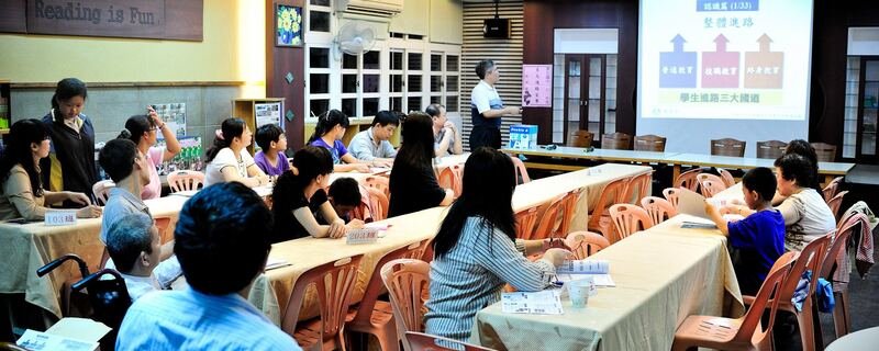 Teacher meeting with parents at school